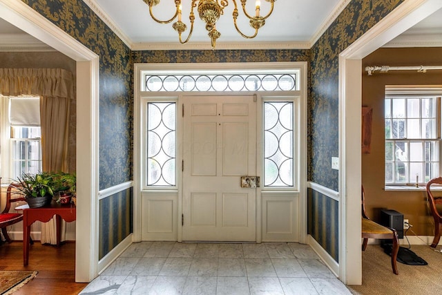 entrance foyer featuring crown molding and a chandelier