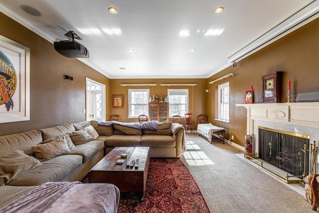 carpeted living room featuring ornamental molding, a fireplace, and a wealth of natural light