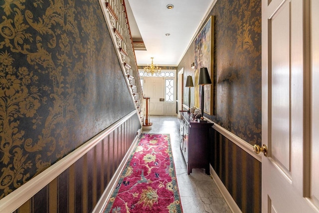 hallway with an inviting chandelier