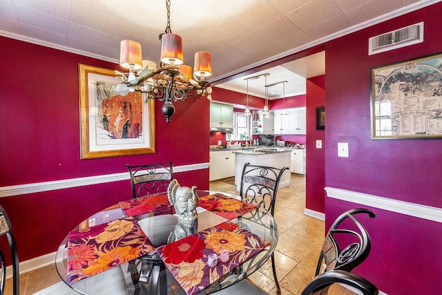 dining space with crown molding and a notable chandelier