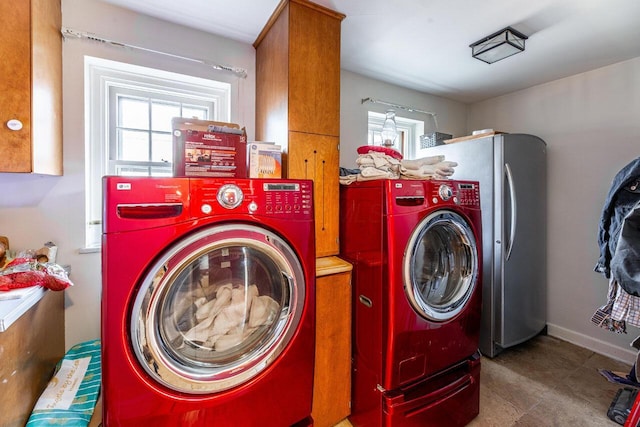 washroom featuring cabinets and separate washer and dryer