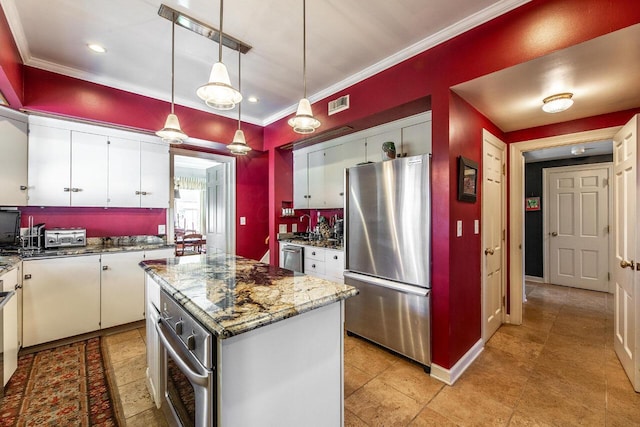 kitchen with white cabinetry, a kitchen island, and appliances with stainless steel finishes