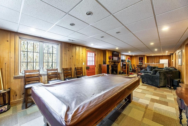 recreation room featuring wood walls, a drop ceiling, and pool table