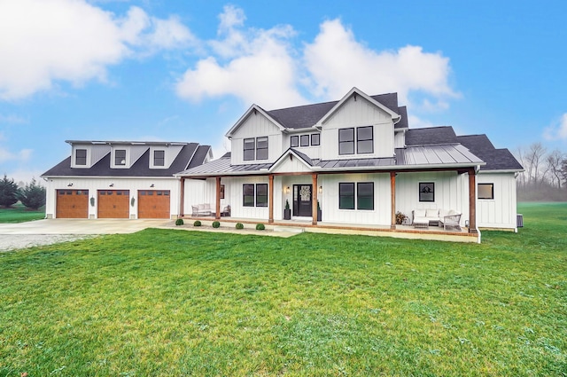 modern farmhouse style home with a front lawn, covered porch, and a garage