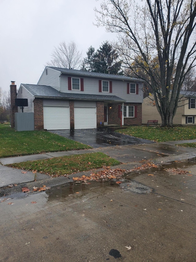 view of property with a front yard and a garage