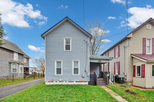 back of house featuring a porch and a lawn