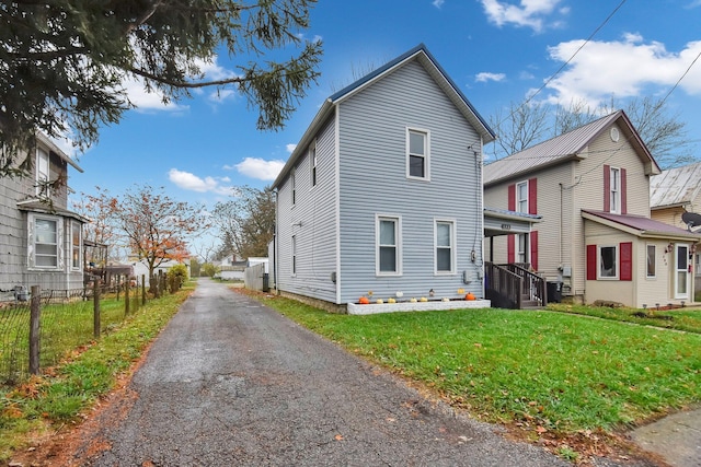 view of side of home featuring a lawn