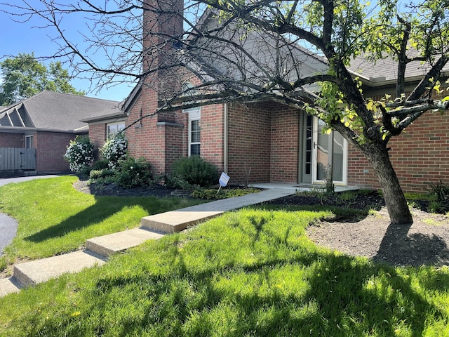 2400 Huntmaster Ln, Grove City, OH 43123 - view of front of property featuring brick siding, a front lawn, and a chimney