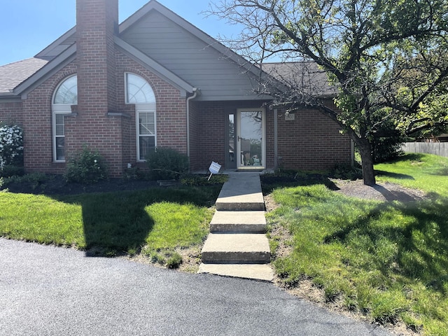 2400 Huntmaster Ln, Grove City, OH 43123 - ranch-style home featuring brick siding, a chimney, and a front lawn