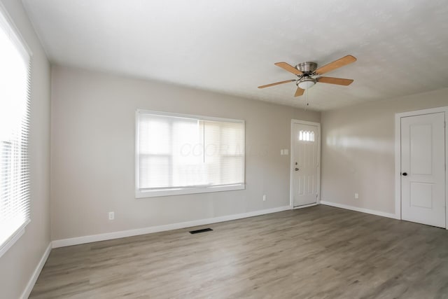 empty room featuring ceiling fan and wood-type flooring