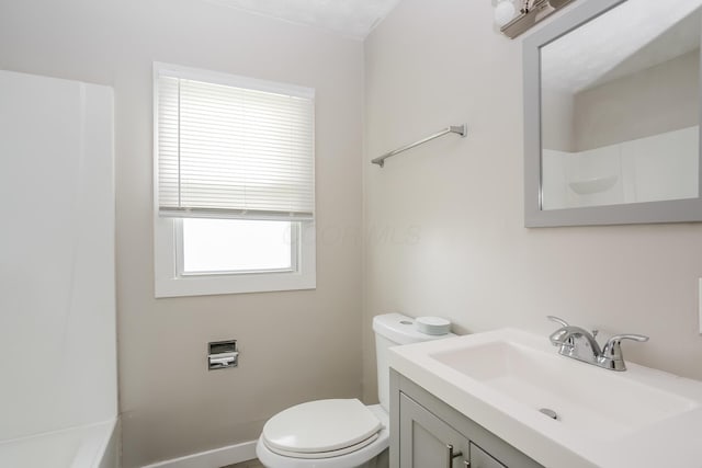 bathroom featuring vanity, toilet, and a wealth of natural light