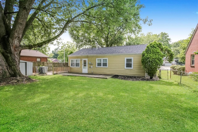 back of house featuring a lawn and a patio area