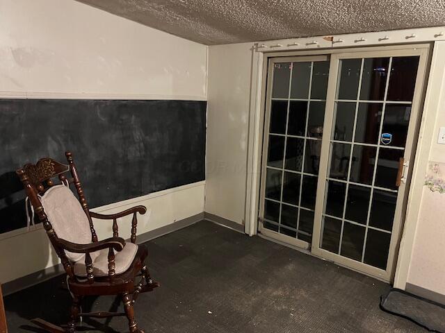 unfurnished room featuring a textured ceiling