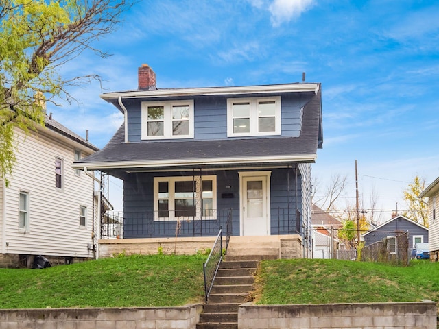 view of front of home featuring a porch and a front yard