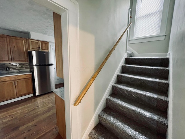 staircase with wood-type flooring