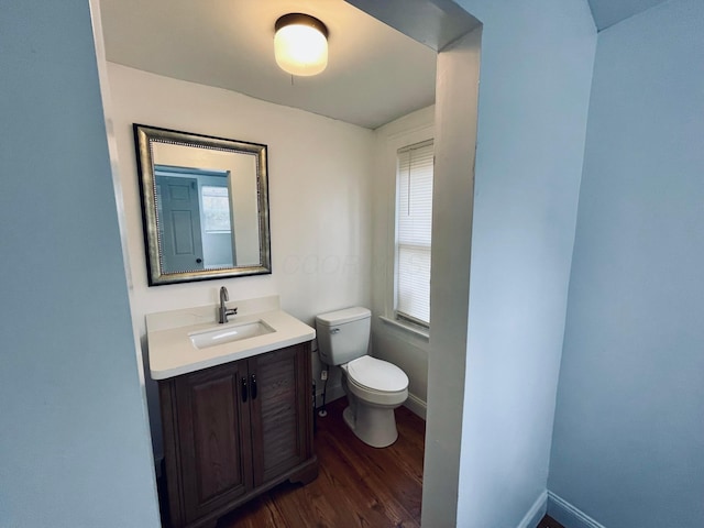 bathroom with hardwood / wood-style floors, vanity, and toilet