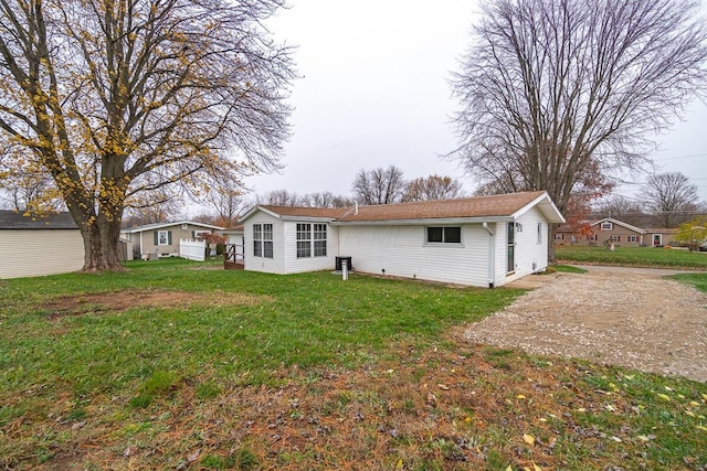 back of house with a lawn