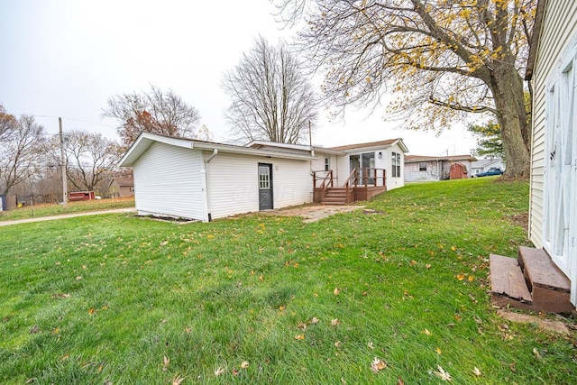 rear view of property with a lawn