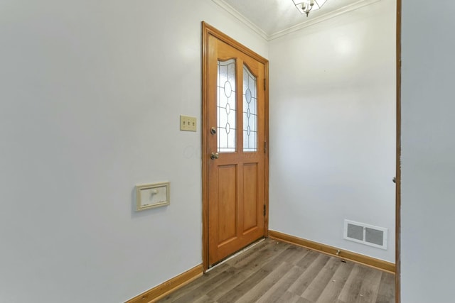 doorway to outside with crown molding and hardwood / wood-style flooring