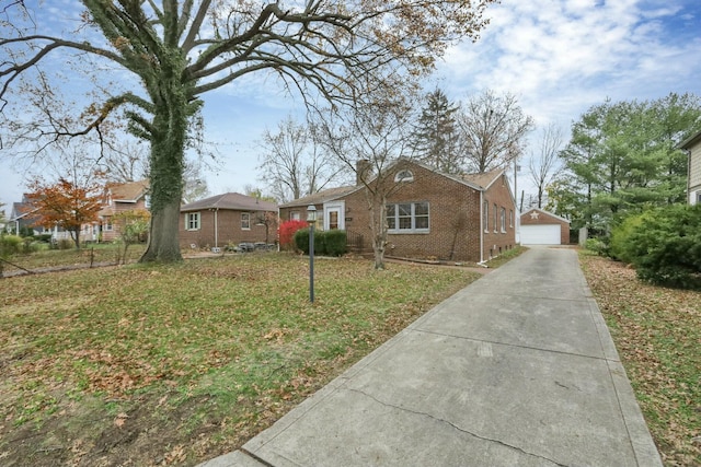 single story home featuring a garage, an outdoor structure, and a front lawn