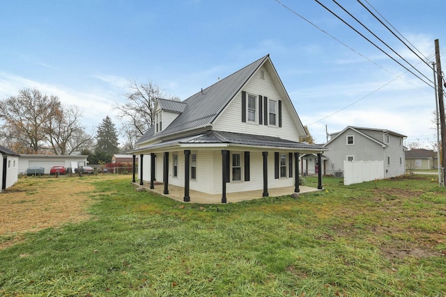 view of side of property with a porch and a yard