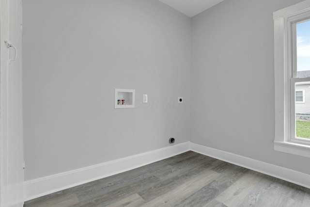 clothes washing area featuring electric dryer hookup, hardwood / wood-style floors, and washer hookup