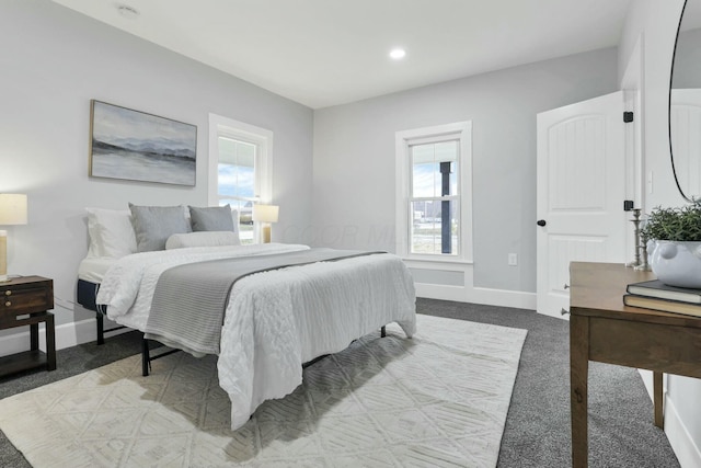 bedroom with carpet floors and multiple windows