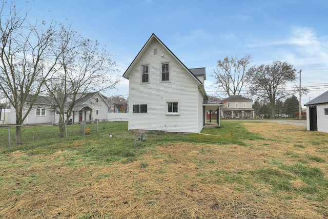 back of property featuring a yard