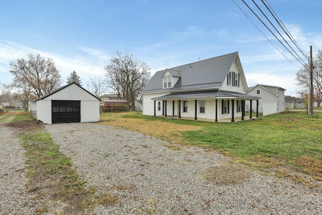 exterior space with an outbuilding, a porch, a yard, and a garage