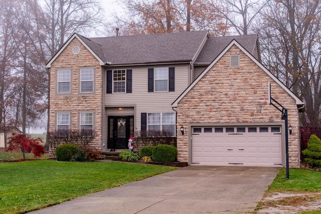 view of front of house featuring a front yard and a garage