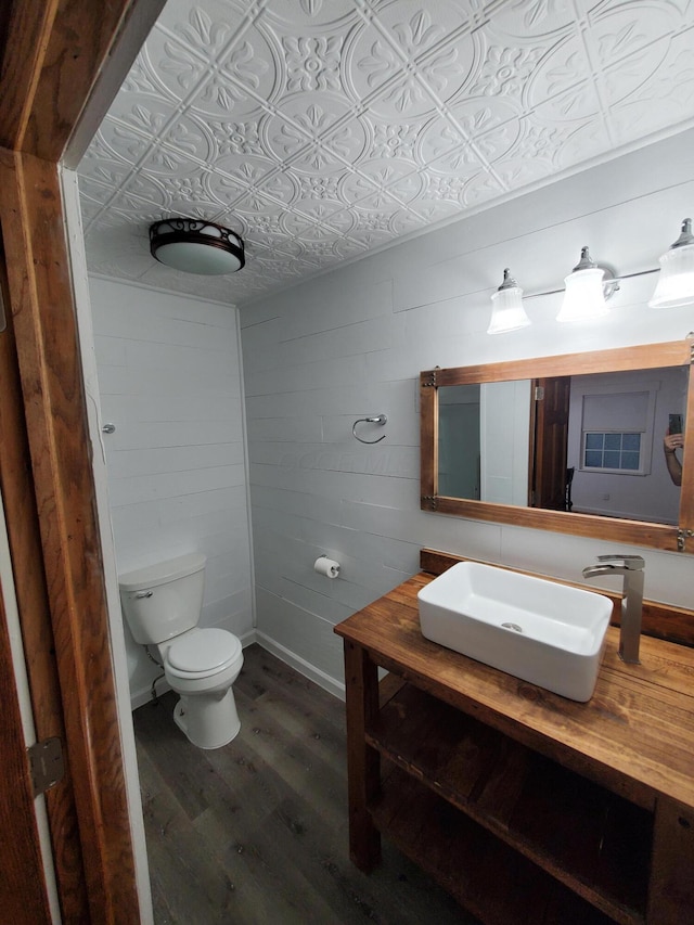 bathroom featuring hardwood / wood-style floors, vanity, and toilet