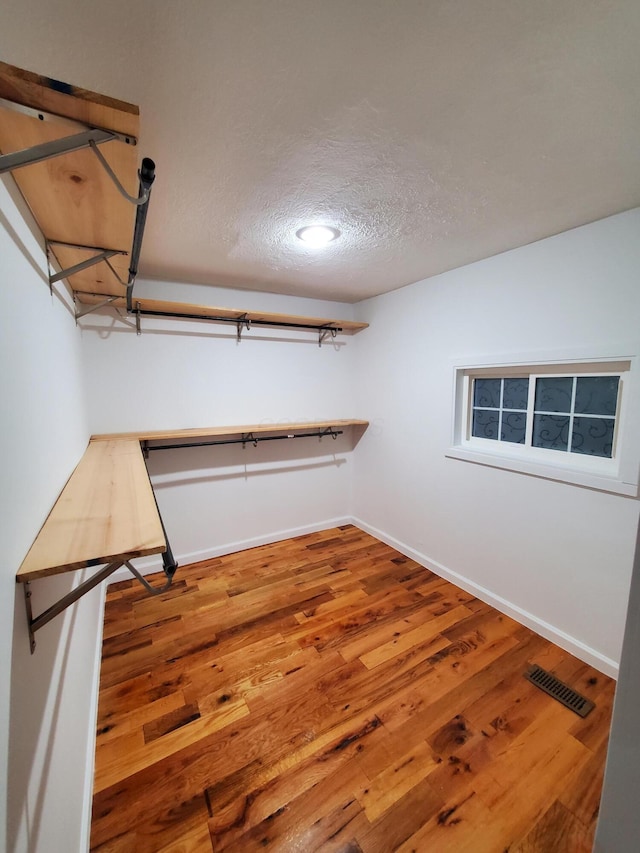 spacious closet with hardwood / wood-style floors