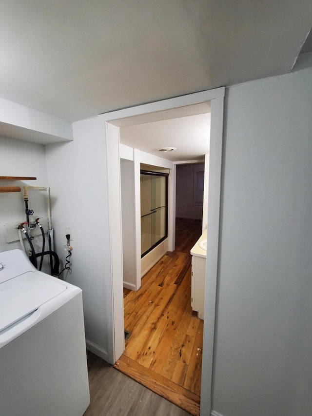 washroom with washer / dryer and wood-type flooring