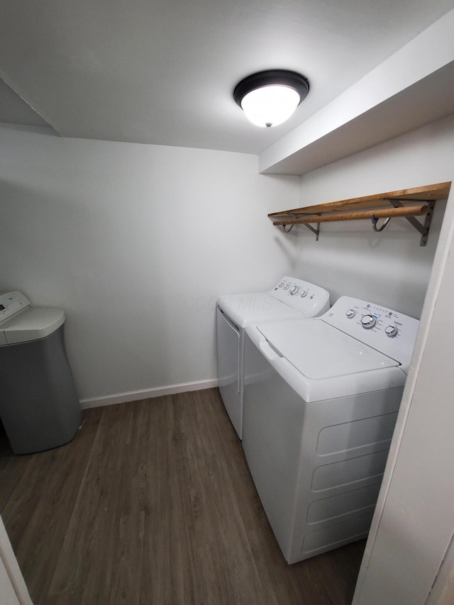 washroom with independent washer and dryer and dark wood-type flooring