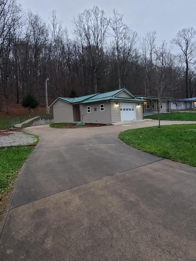 view of front of property with a garage and a front lawn