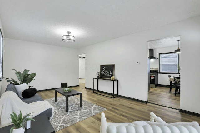 living room with hardwood / wood-style flooring and a textured ceiling