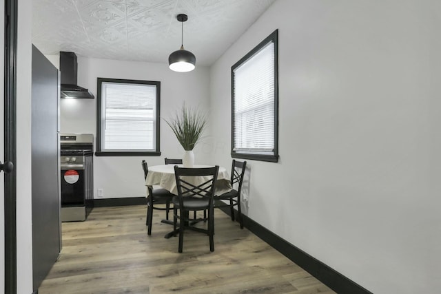 dining area with a healthy amount of sunlight and wood-type flooring