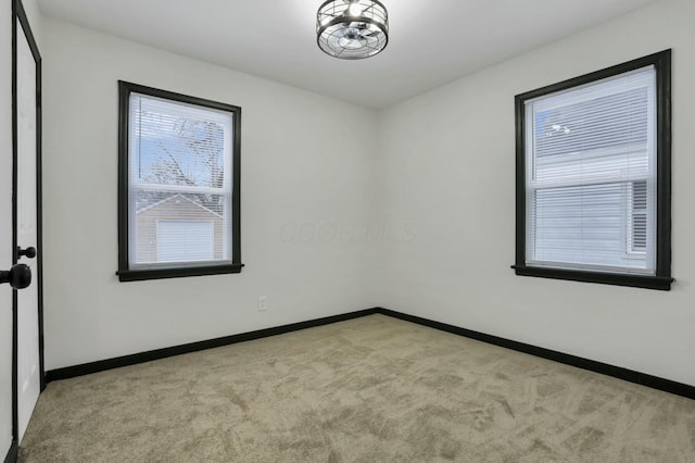 unfurnished room featuring light carpet