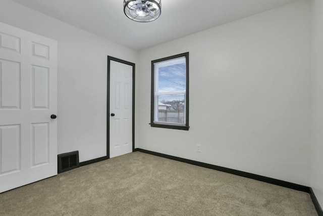 unfurnished bedroom with light colored carpet