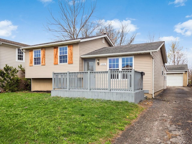 view of front of home with an outbuilding, a garage, and a front lawn