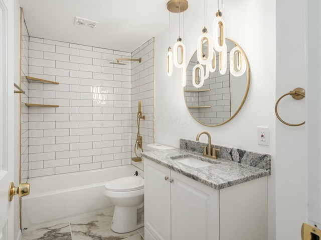 full bathroom with vanity, toilet, and tiled shower / bath