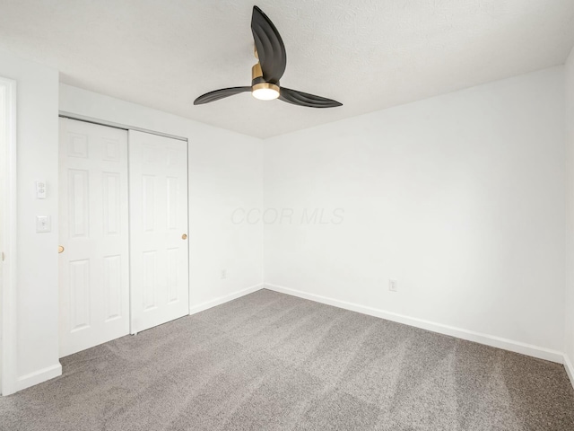 unfurnished bedroom featuring carpet, a closet, and ceiling fan