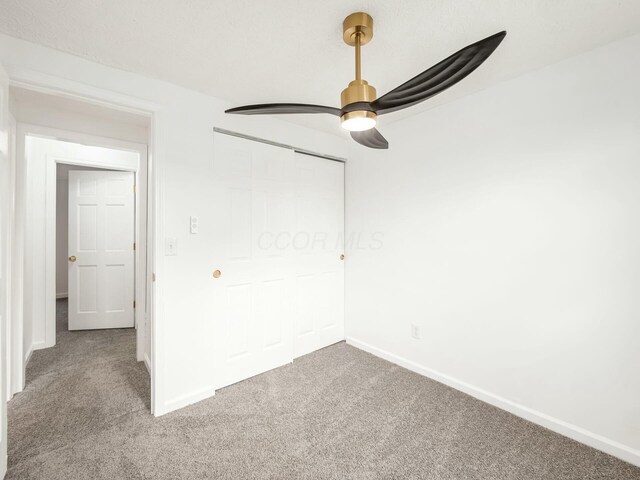 5006 Old Tree Ave, Columbus, OH 43228 - unfurnished bedroom with carpet, a closet, and a ceiling fan