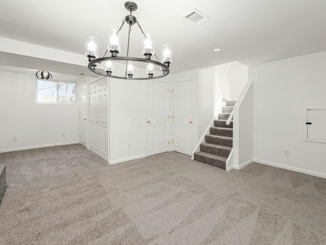 interior space featuring carpet floors and an inviting chandelier