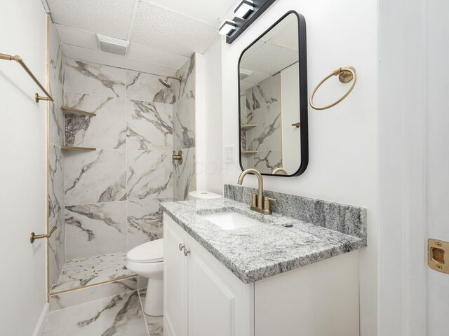 5006 Old Tree Ave, Columbus, OH 43228 - bathroom featuring a paneled ceiling, vanity, marble look tile flooring, and a marble finish shower