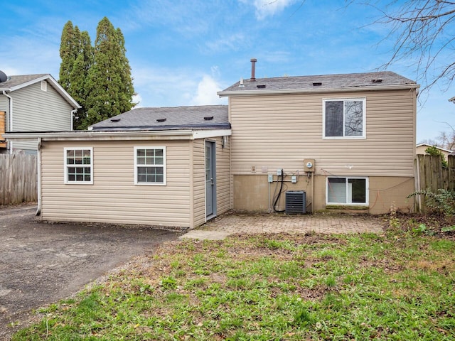 rear view of house featuring central AC