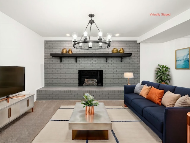 carpeted living room featuring a brick fireplace, brick wall, and an inviting chandelier