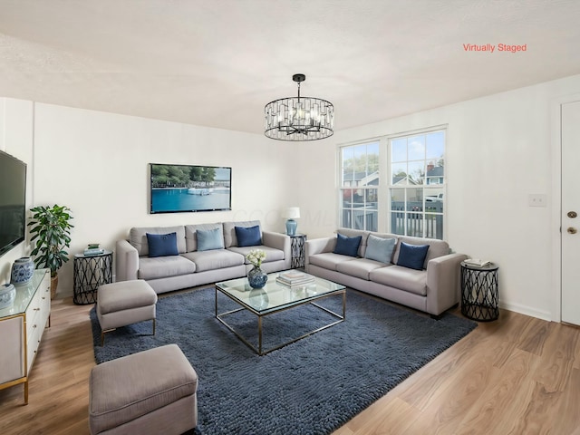 living room featuring hardwood / wood-style flooring and a chandelier