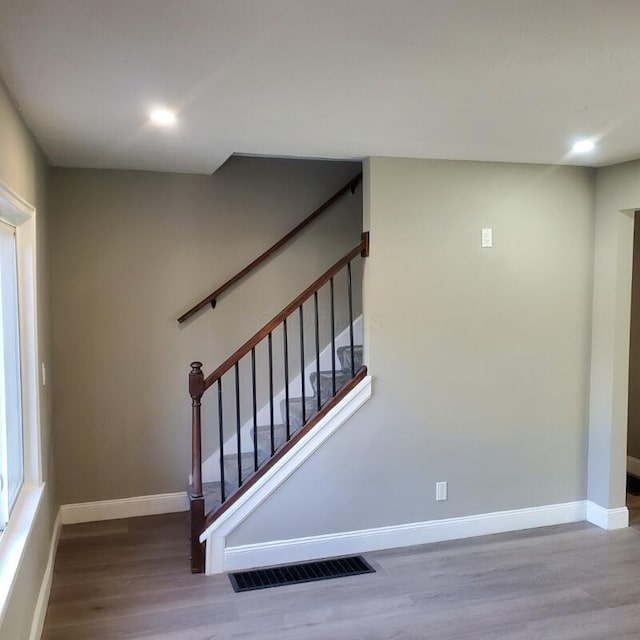 staircase with wood-type flooring