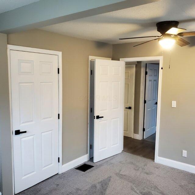 unfurnished bedroom featuring carpet flooring and ceiling fan